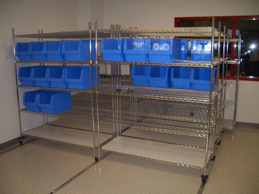 Empty metal shelves with blue storage bins